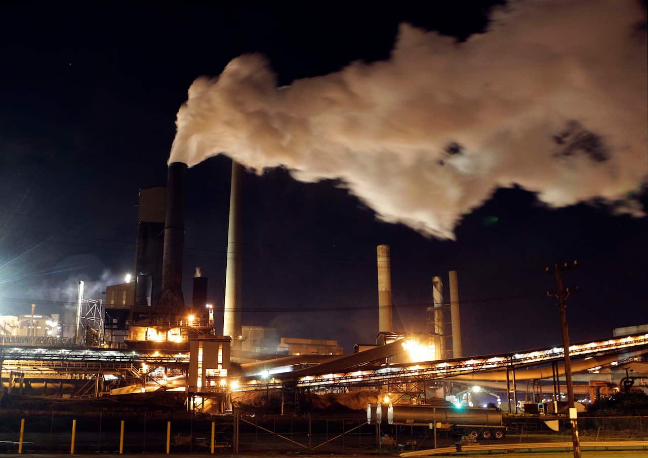Smoke bellows out of a chimney stack at Bluescope Steel works at Port Kembla 84km south of  Sydney,  