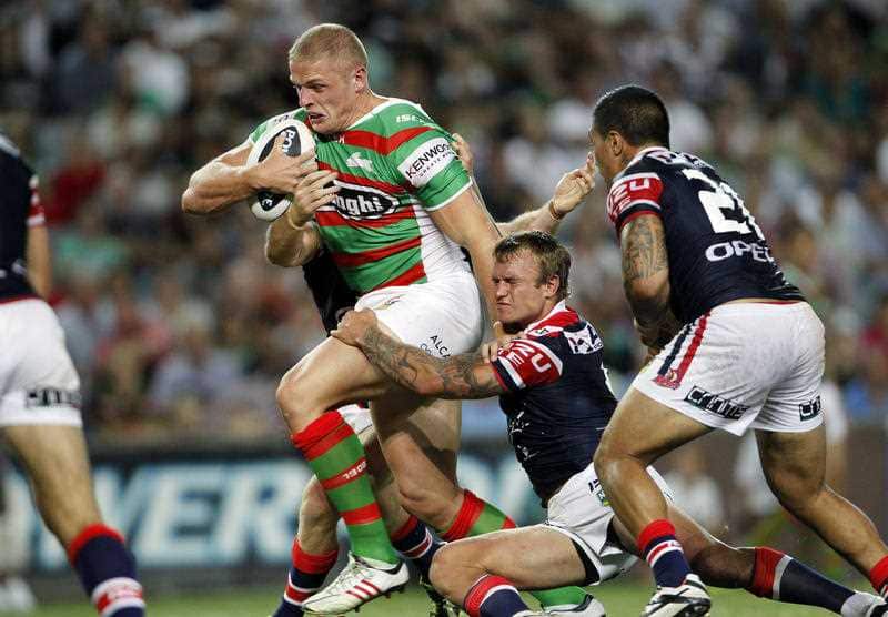 George Burgess busts through the tackle of Jake Friend during the NRL Round 1, Sydney Roosters v South Sydney Rabbitohs, at Allianz Stadium in Sydney, Thursday, March 7, 2013. (AAP Image/Action Photographics, Renee McKay)