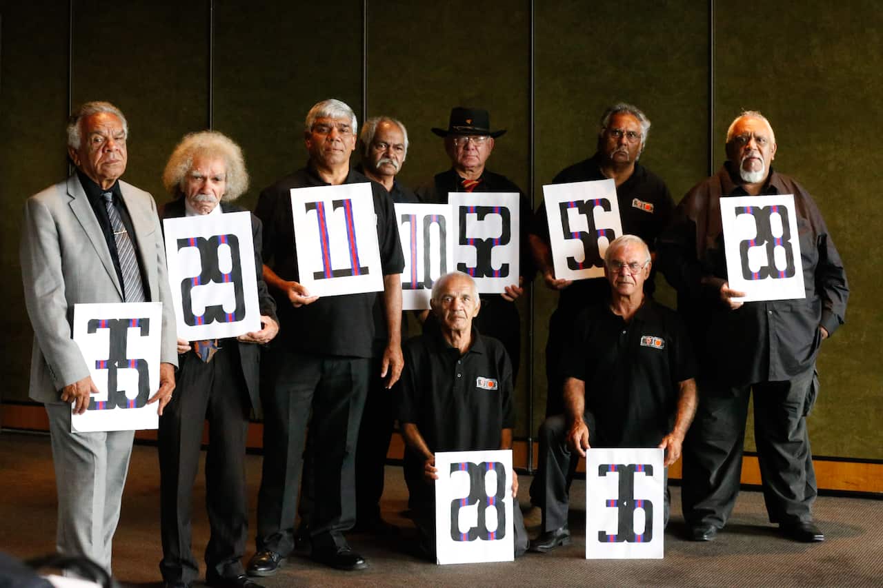 Survivors of the Kinchela Boys Home pose for a photograph with the assigned numbers they were given when they were taken there.  