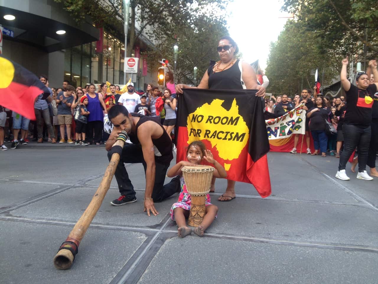  A man plays the didgeridoo as protesters in Melbourne stop traffic on March 19, 2015 to rally against the planned closure of up to 150 remote communities in Western Australia