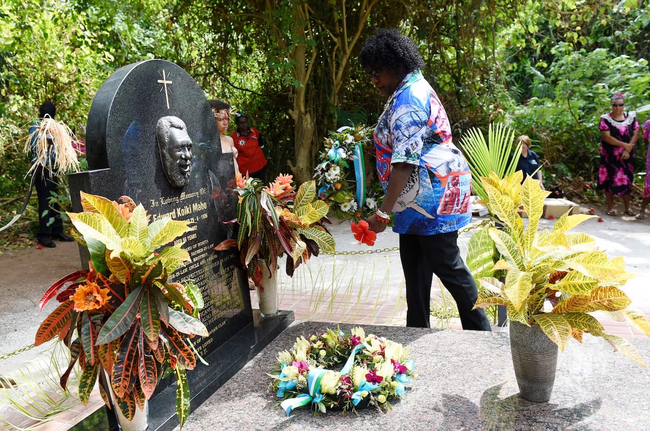Gail Mabo lays a wreath as Prime minister Tony Abbott visits the grave of land rights activist Eddie Mabo on Mer Island in the Torres Strait