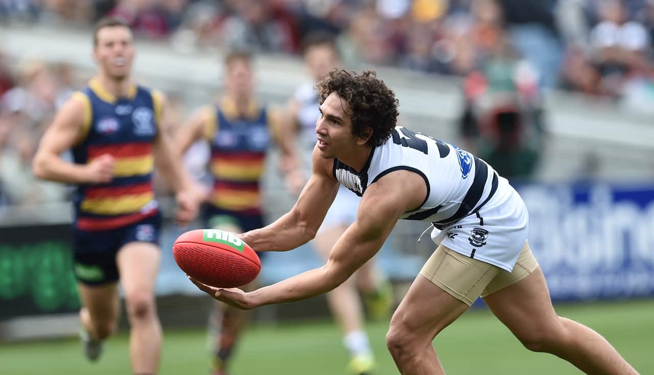 Geelong Cats player Nakia Cockatoo handballs against the Adelaide Crows in round 23 of the AFL at Simonds Stadium in Geelong, Saturday, Sept. 5, 2015. (AAP Image/Julian Smith) NO ARCHIVING, EDITORIAL USE ONLY