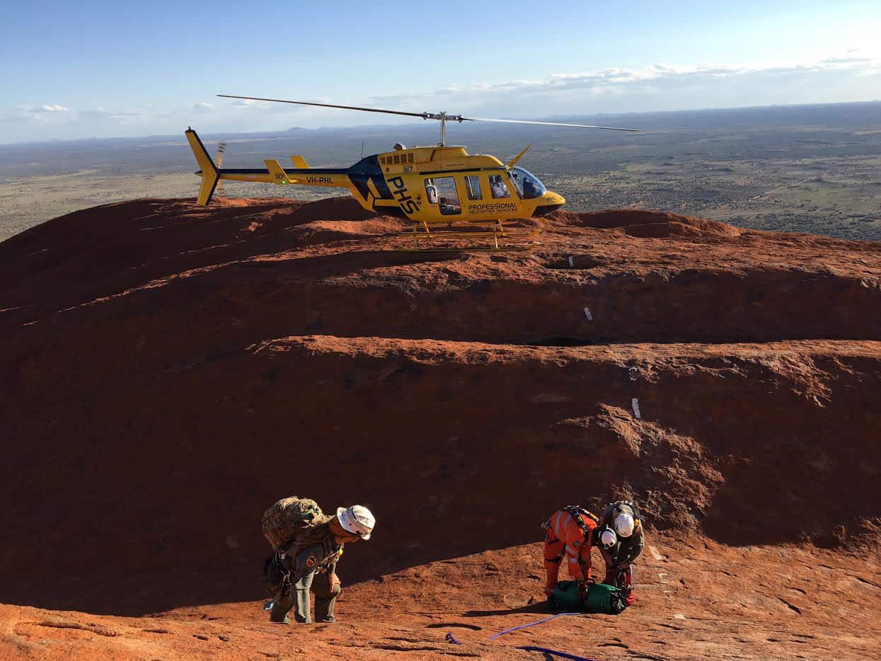 Specialist climbers rescued three men who became stuck atop Uluru after climbing the landmark The Northern Territory, 2016