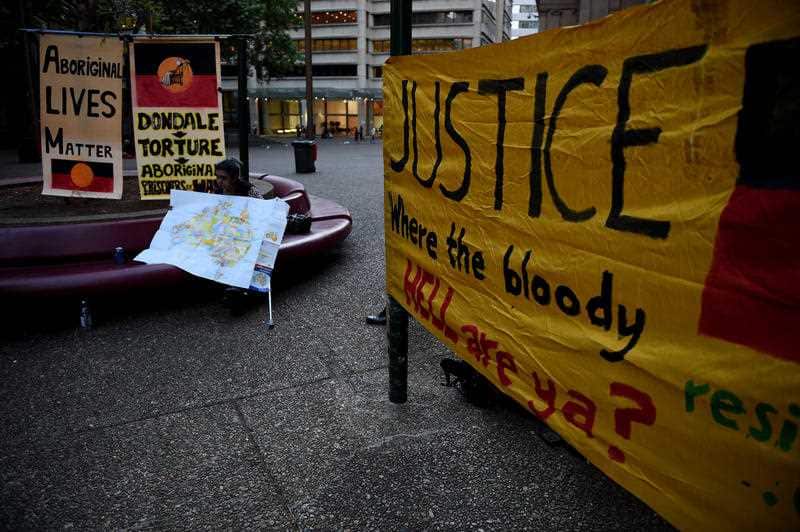 Banners at a rally during the public hearings for the royal commission into youth detention and child protection in the Northern Territory.