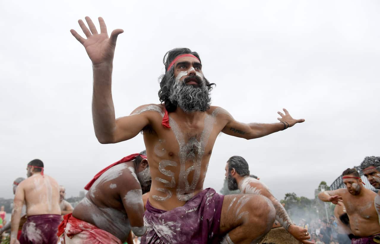 Koomurri dancers perform the smoking ceremony and dance during the WugulOra Morning Ceremony on January 26 in Sydney