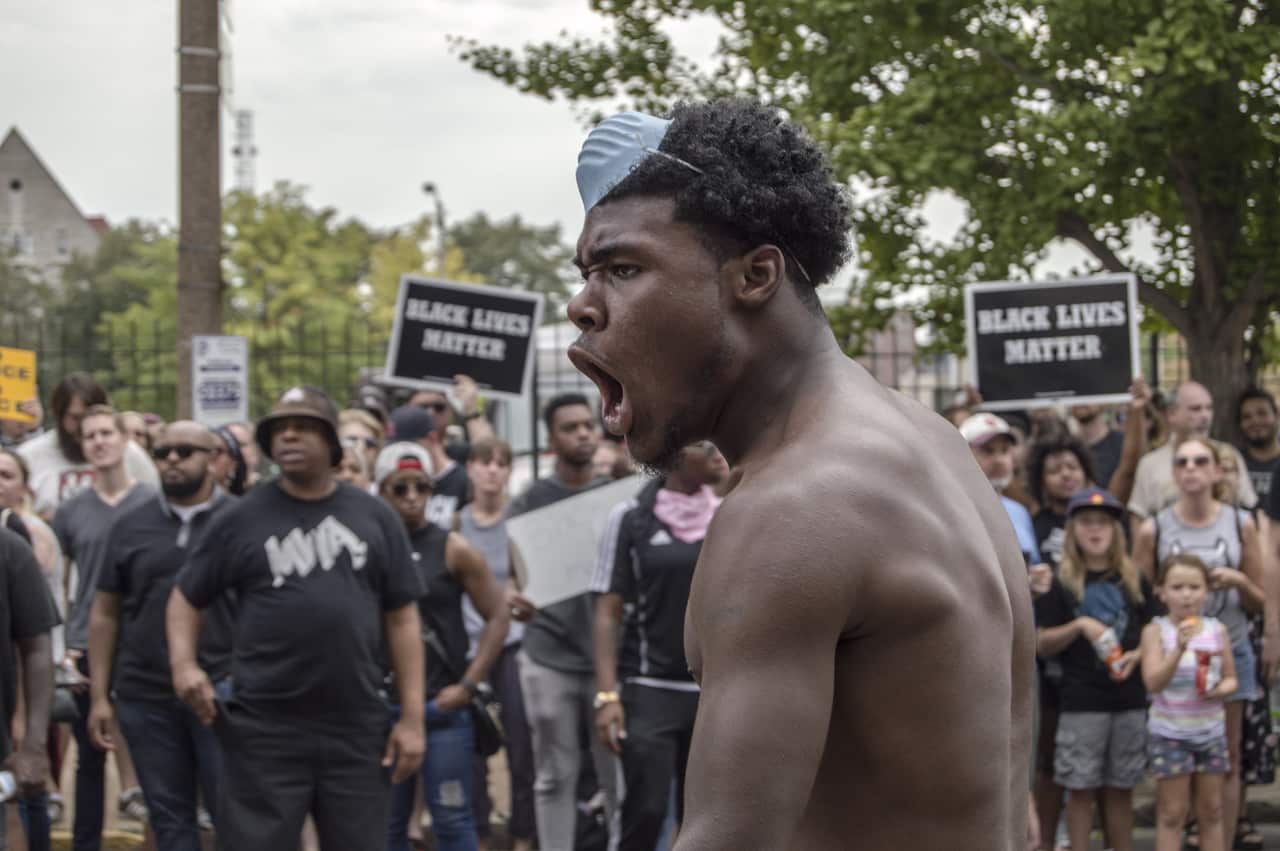 Protesters gather at a peaceful rally in front of St. Louis Metropolitan Police Headquarters in St. Louis