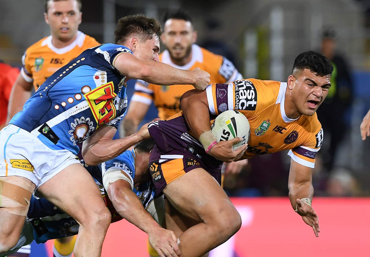 David Fifita of the Broncos is tackled during the Round 17 NRL match between the Gold Coast Titans and the Brisbane Broncos at Cbus Super Stadium in Robina on the Gold Coast. Sunday, July 8, 2018. (AAP Image/Dave Hunt) NO ARCHIVING, EDITORIAL USE ONLY