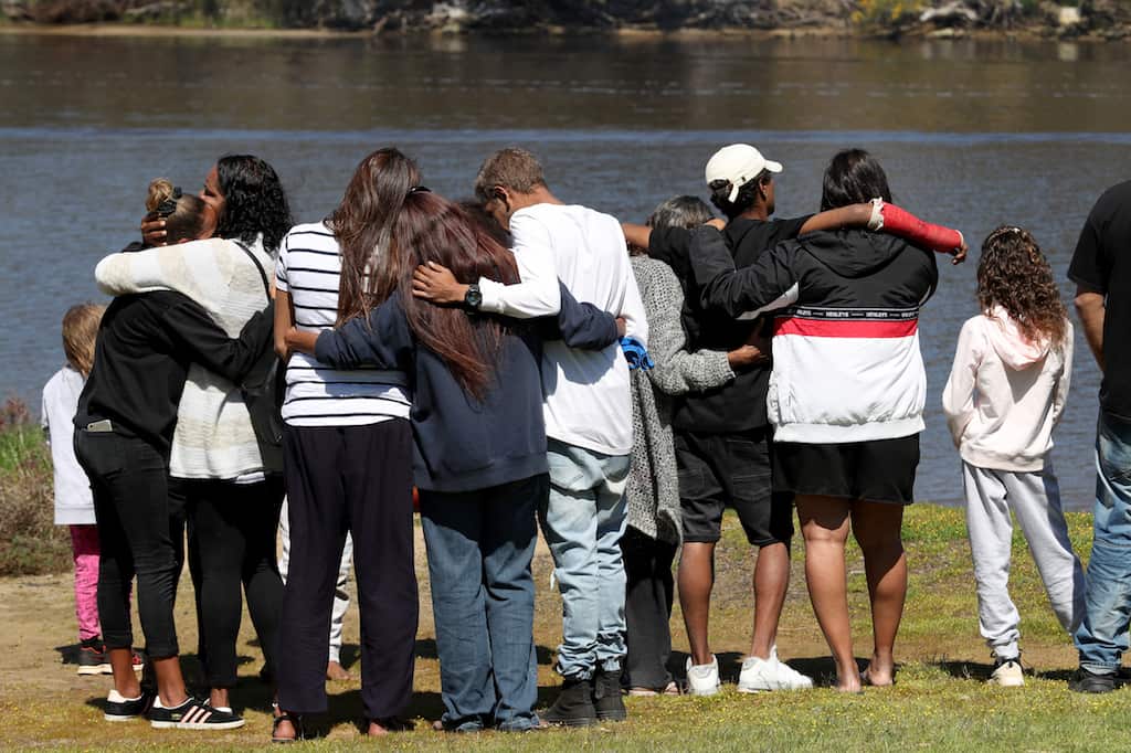 Children mourning the loss of their friends, drowned during a police chase in Perth, W.A.