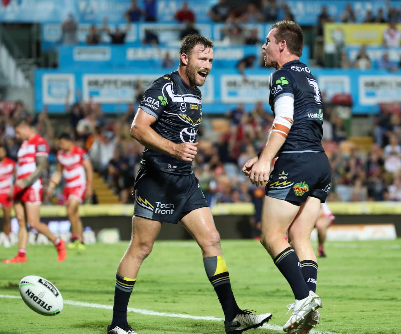 Gavin Cooper of the Cowboys congratulates Michael Morgan of the Cowboys on his try during the Round 1 NRL match. (AAP Image/Michael Chambers) 