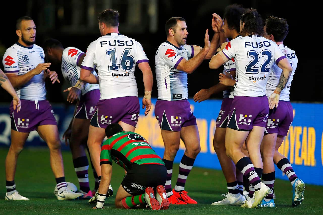 Brodie Croft of the Storm celebrates scoring a try against the Rabbitohs.