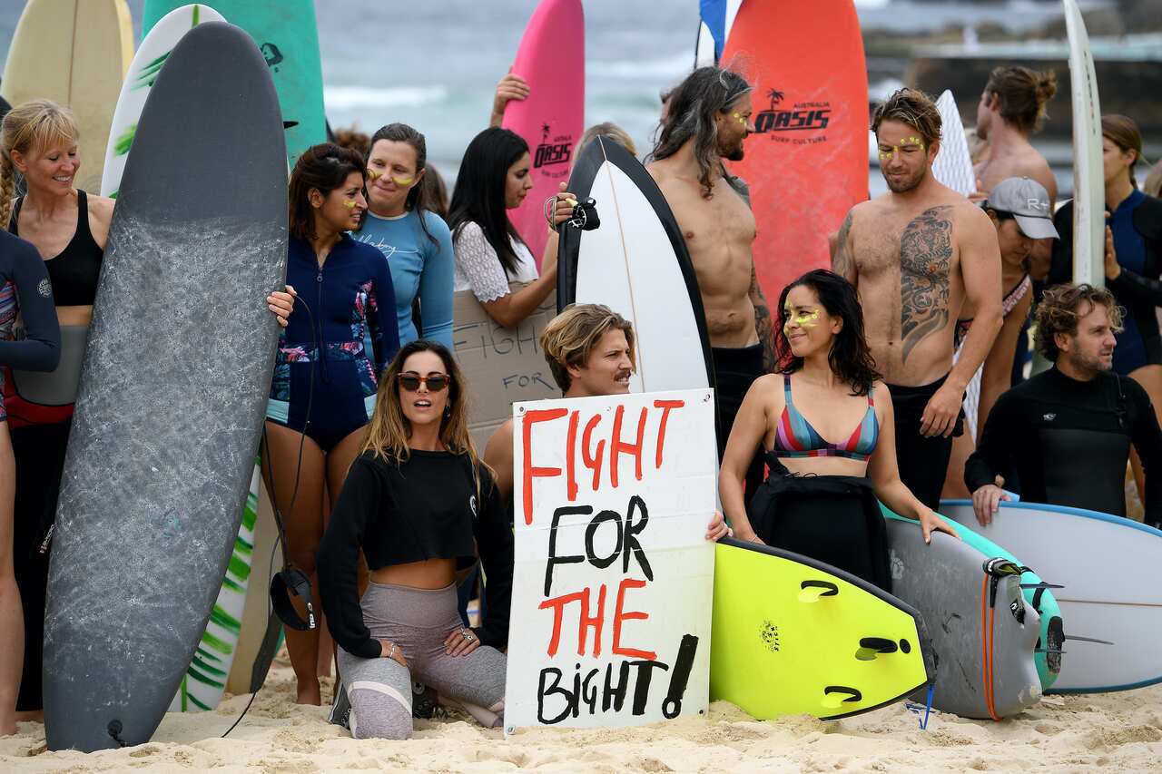 Protesters assemble prior to taking part in a paddle out protest rally at Bondi Beach, Sydney, Saturday,
