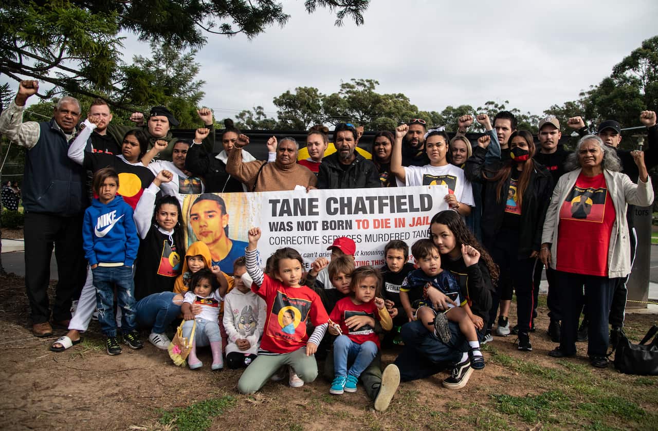 Supporters of Tane Chatfields parents Colin and Nioka Chatfield pose with them for a photograph outside the inquest into Tane Chatfields death.