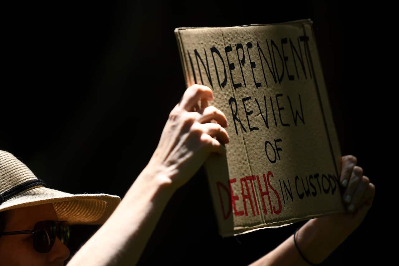 Protestors hold placards during a Black Lives Matter rally in Sydney.
