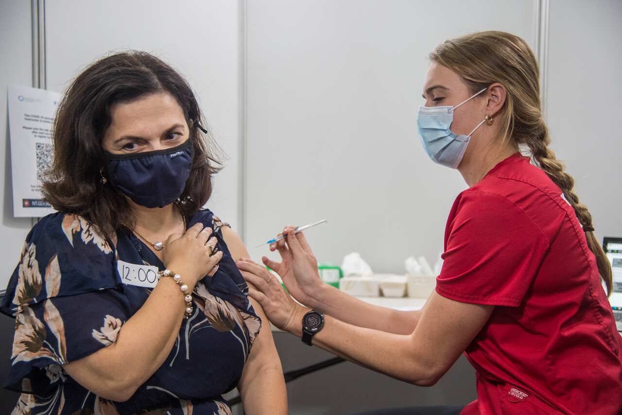 A Northern Territory health worker gives an eligible Territorian their first does of the Pfizer COVID-19 vaccine at the new Darwin COVID-19 Vaccination Centre in Marrara, Darwin, Wednesday, July 7, 2021. (AAP Image/Aaron Bunch) NO ARCHIVING