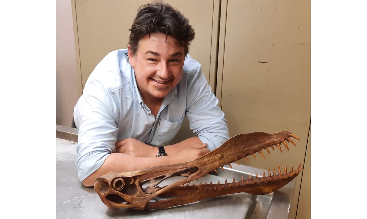 UQ PhD candidate Tim Richards with the skull 