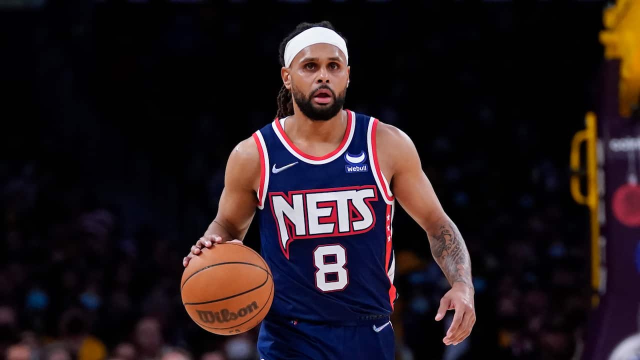 Brooklyn Nets guard Patty Mills (8) controls the ball during an NBA basketball game against the Los Angeles Lakers in Los Angeles, Saturday, Dec. 25, 2021. (AP Photo/Ashley Landis)