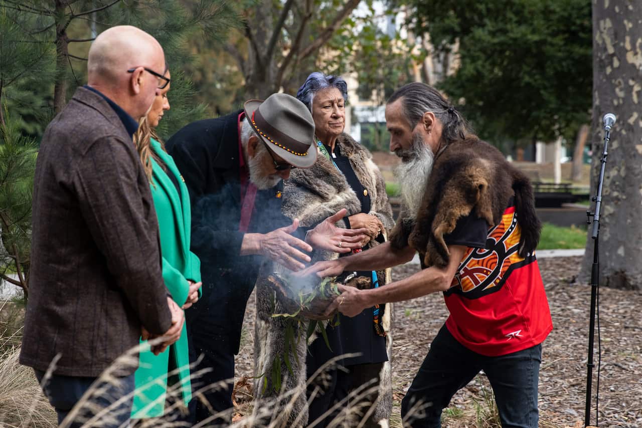 Uncle Collin Hunter Jr (right) is seen during a smoking ceremony during the launch of the Yoo-Rrook Justice Commission in Fitzroy, Melbourne, Wednesday, March 23, 2022. (AAP Image/Diego Fedele) NO ARCHIVING