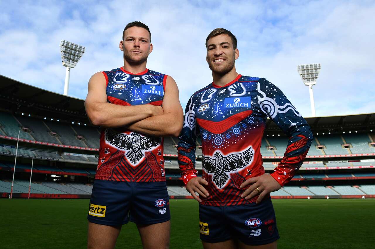 Melbourne Demons AFL players Steven May and Jack Viney pose for a photo with an Indigenous design Guernsey during an announcement ahead of the Sir Doug Nicholls Round at the MCG, in Melbourne, Monday, May 2, 2022. (AAP Image/Joel Carrett) NO ARCHIVING