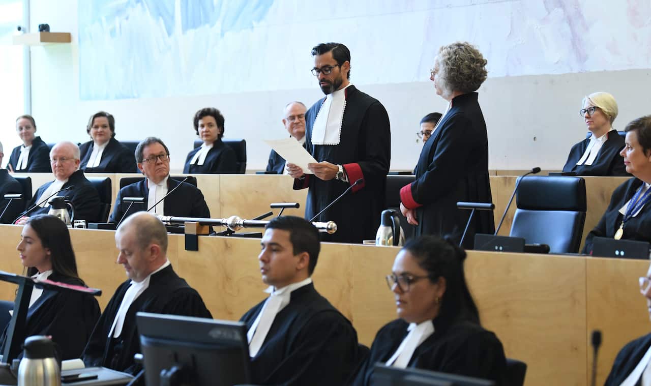 Lincoln crowley reads before the assembled court