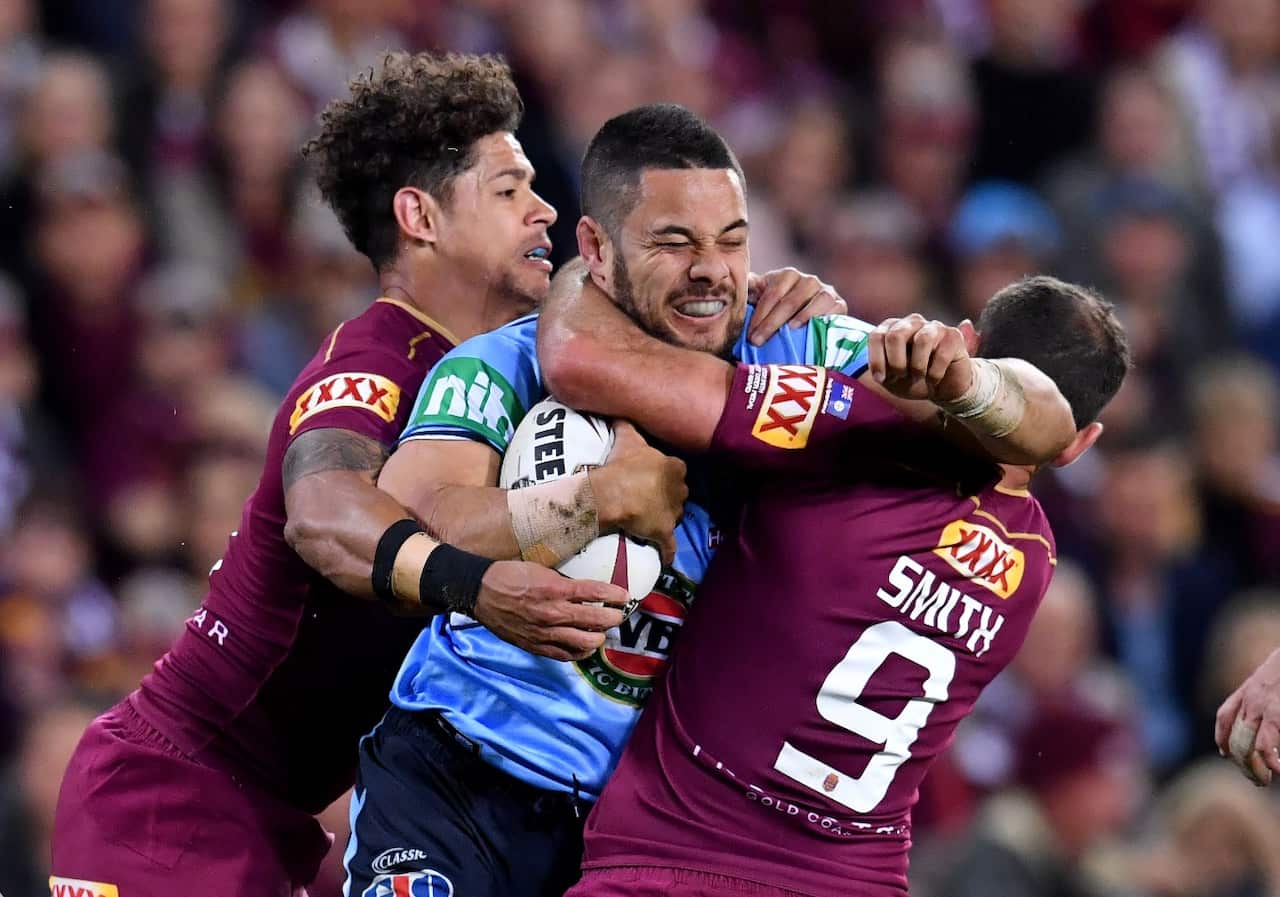 Jarryd Hayne of the Blues tackled by Dane Gagai (left) and Cameron Smith (right) of the Maroons during State of Origin game 3 