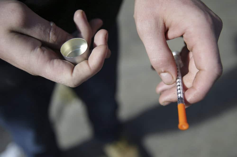 A person holds a syringe. A new report shows Victorians are experiencing high rates of drug use.