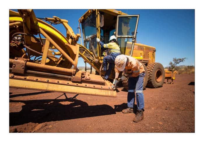 Indigenous workers carry out running repairs on giant machinery as part of their daily work at Christmas Creek mine in the Pilbara, Western Australia. Picture supplied