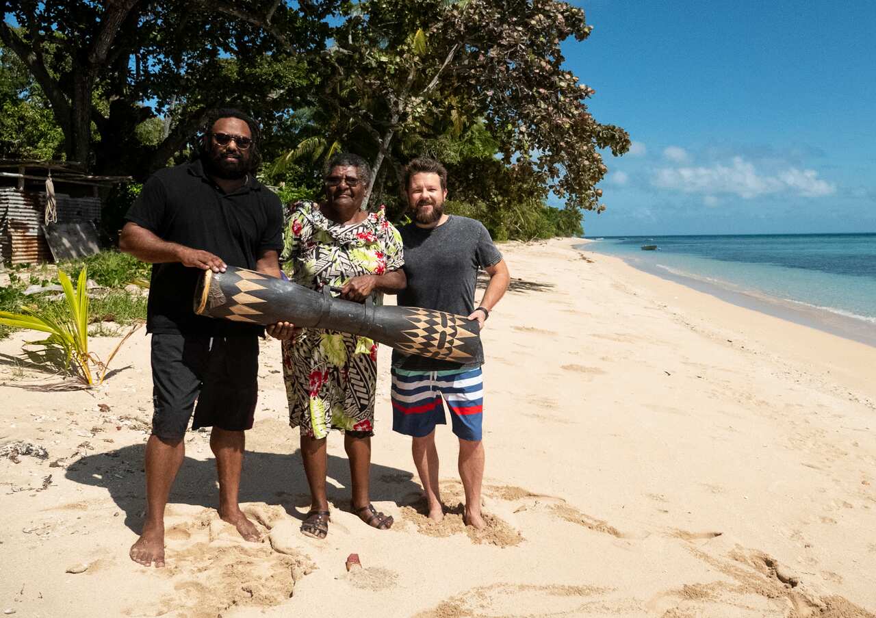 Jeremy Marou and Thomas Busby with Lillah Noah, Jeremy’s grandmother, and the sacred drum the Wasikor.