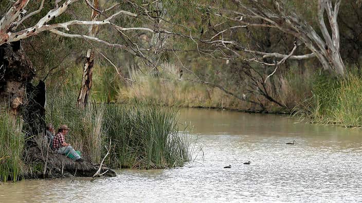 Two locals fish in the Murray river in Wentworth, 1,043 kilometers from Sydney (AP)