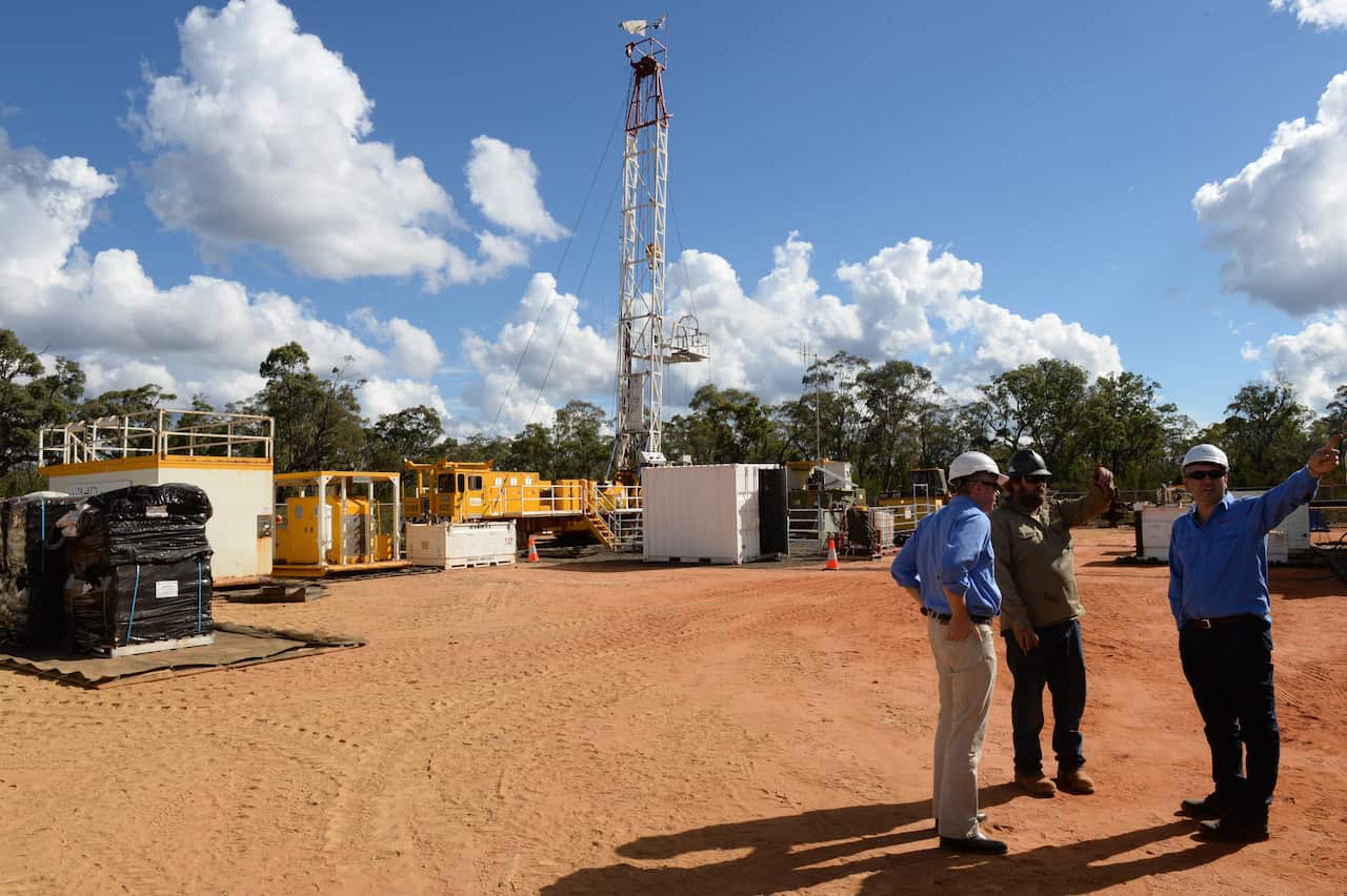 Santos staff at a coal seam gas (CSG) well rig in the Pilliga forest which is part of Santos's Narrabri Gas Project, Narrabri, Friday, May 23, 2014. (AAP Image/Dean Lewins) NO ARCHIVING
