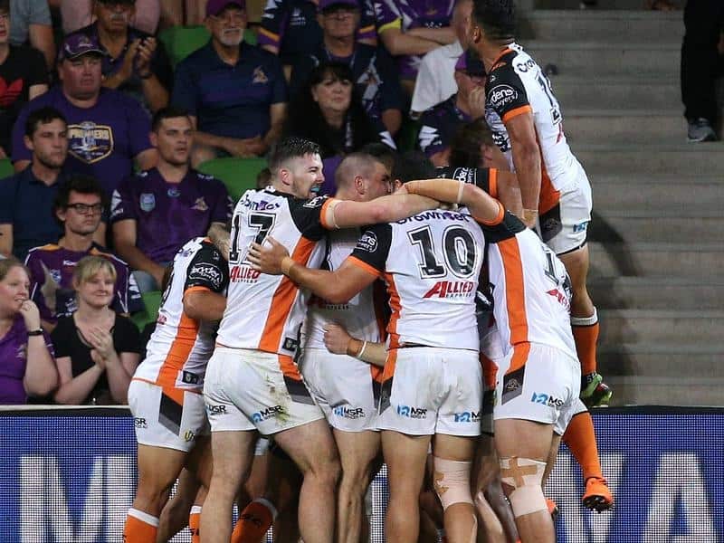 The Tigers celebrate a late try.