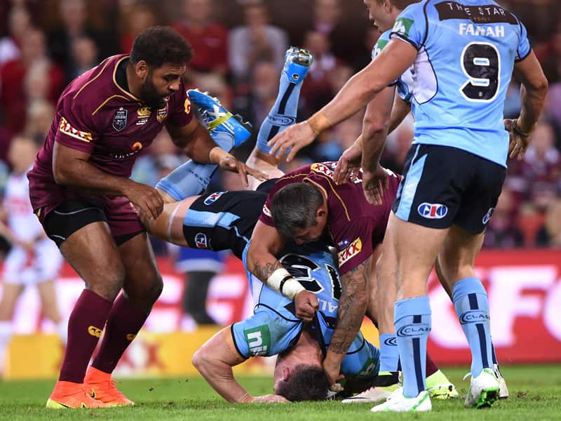 Queensland's Sam Thaiday (L) lifts NSW's Paul Gallen in a tackle