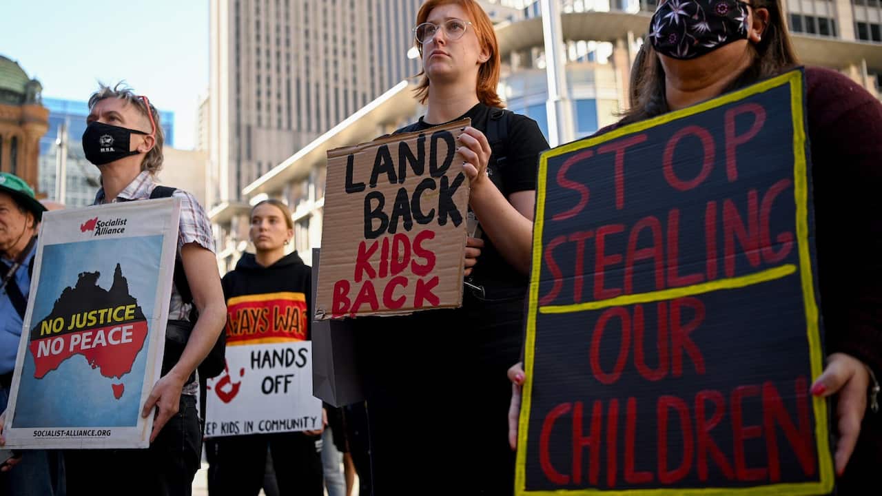 Protesters hold placards during a Stop The Stolen Generation! Sorry Day Rally, Sydney, Wednesday, May 26, 2021. 