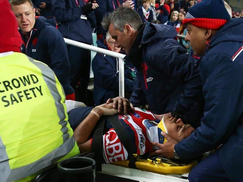 Latrell Mitchell is taken from the Allianz Stadium turf.