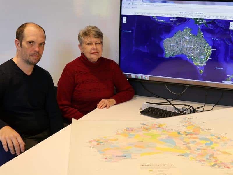Dr Bill Pascoe and Professor Lyndall Ryan sit beside the digital map.