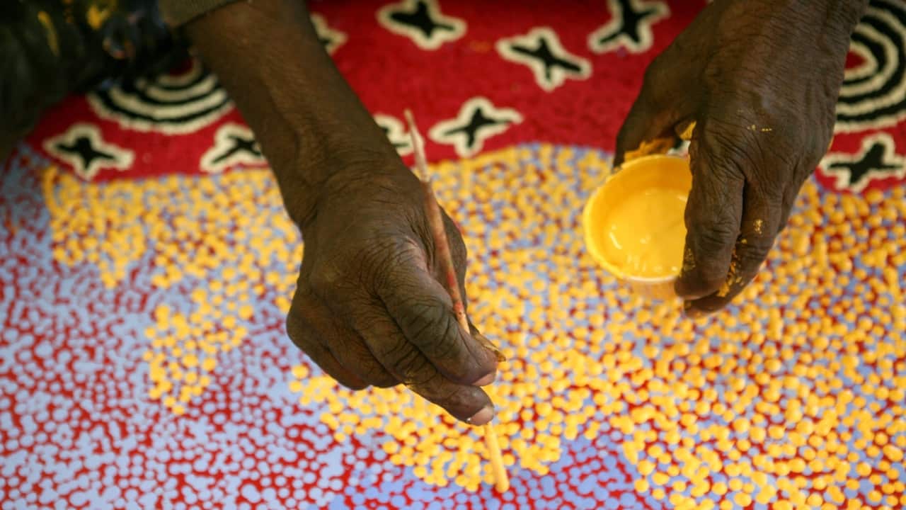Aboriginal artist Paddy Stewart works on a dot painting at the Ngurratjuta Iltja Ntjarra Many Hands Art Center in Alice Springs in the Northern Territory, Jun 23, 2008. The Ngurratjuta Art Centre was established in 2003 to provide a place for Western Arra