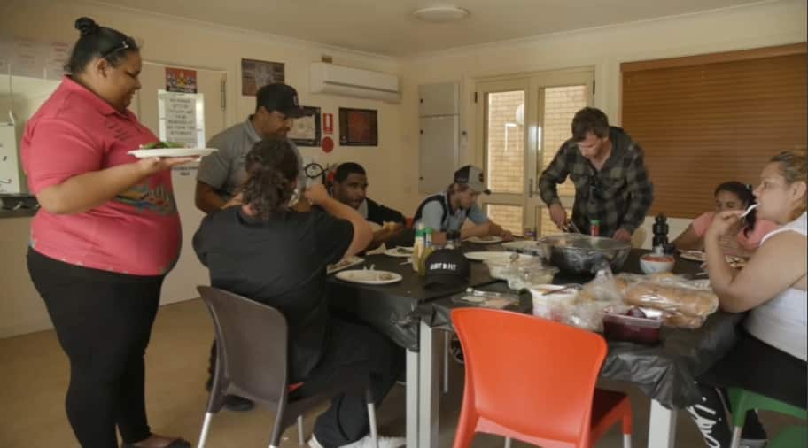 Current patients and staff having lunch in the communal kitchen. 