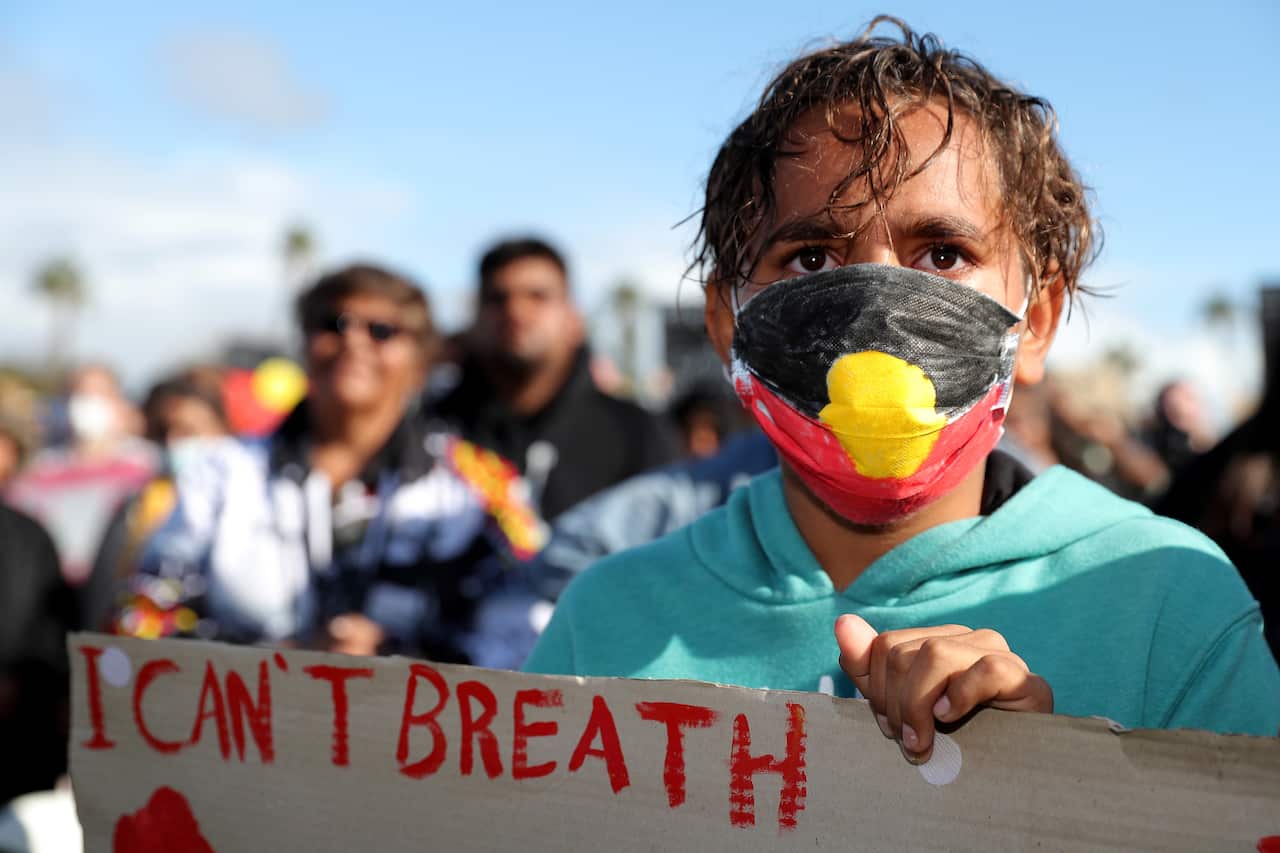 Protesters participate in a Black Lives Matter rally at Langley Park in Perth, Saturday, June 12, 2020. The protest is to raise awareness of Aboriginal Deaths in Custody. (AAP Image/Richard Wainwright) NO ARCHIVING