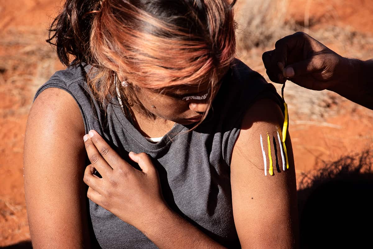 Girls painted up Seven Sisters Cave Hill APY Lands