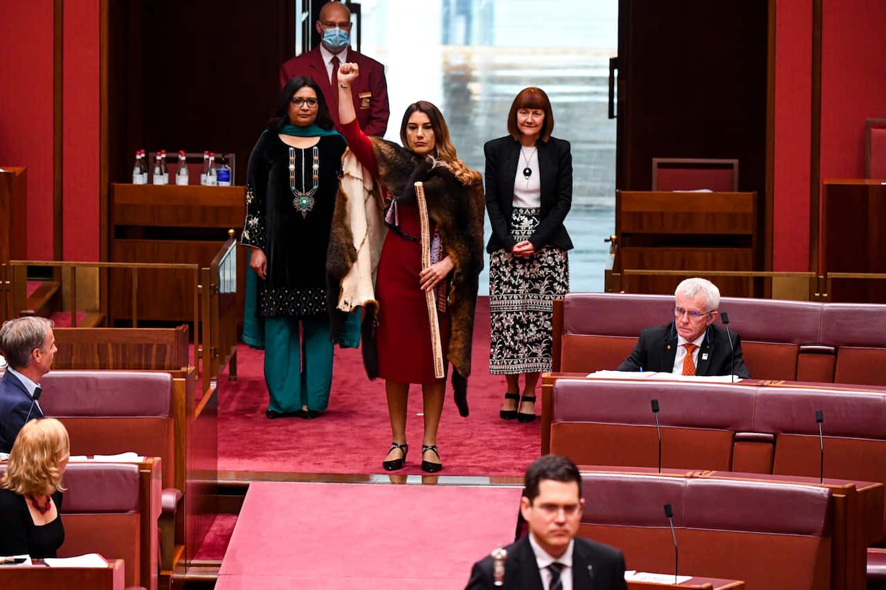 Australian Greens Senator Lidia Thorpe lifts arrives in the Senate chamber.