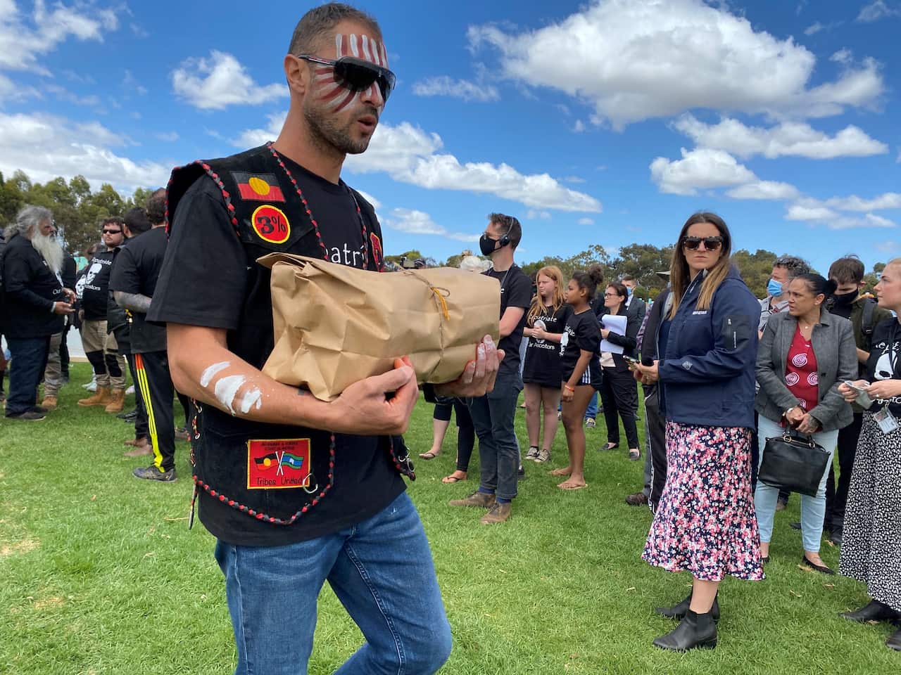 A member of the Black Death Motorcycle Club holding the remains.