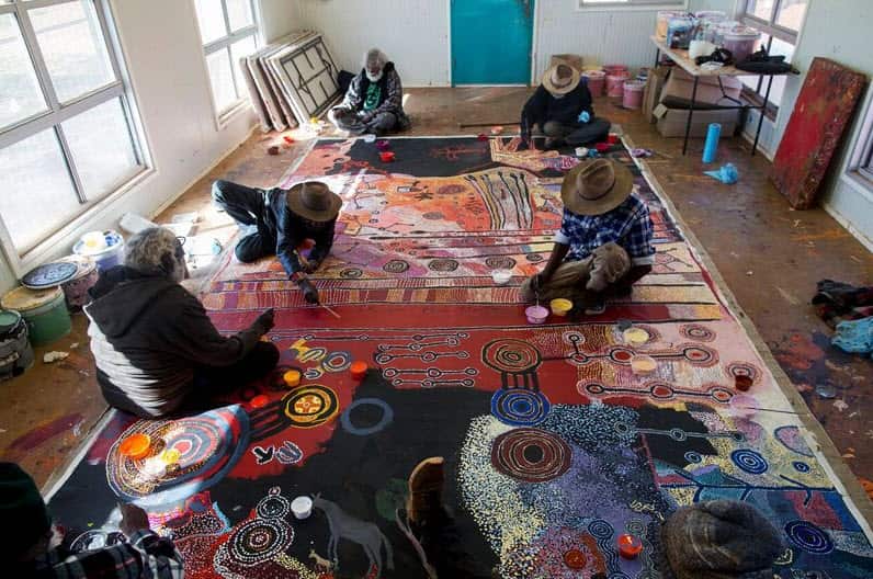 Artists at work at Tjala Arts (Photo Credit: Rhett Hammerton).
