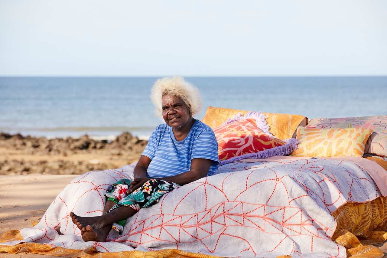 ARTIST JANET MARAWARR WITH HER ARTWORK KUNKURRA, 2015. COPYRIGHT: JANET MARAWARR/LICENSED BY COPYRIGHT AGENCY. USED WITH PERMISSION . PHOTOGRAPHER CAITLIN MILLS