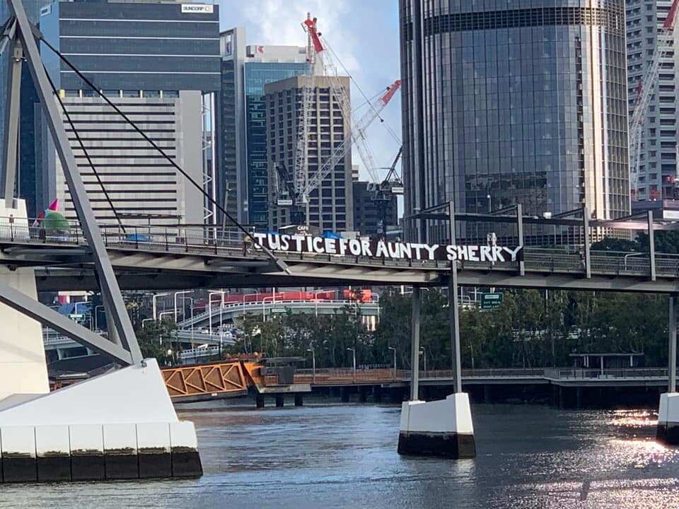 A banner hangs across a bridge in Brisbane with the words, 'Justice for Aunty Sherry' on Friday 18 September. 