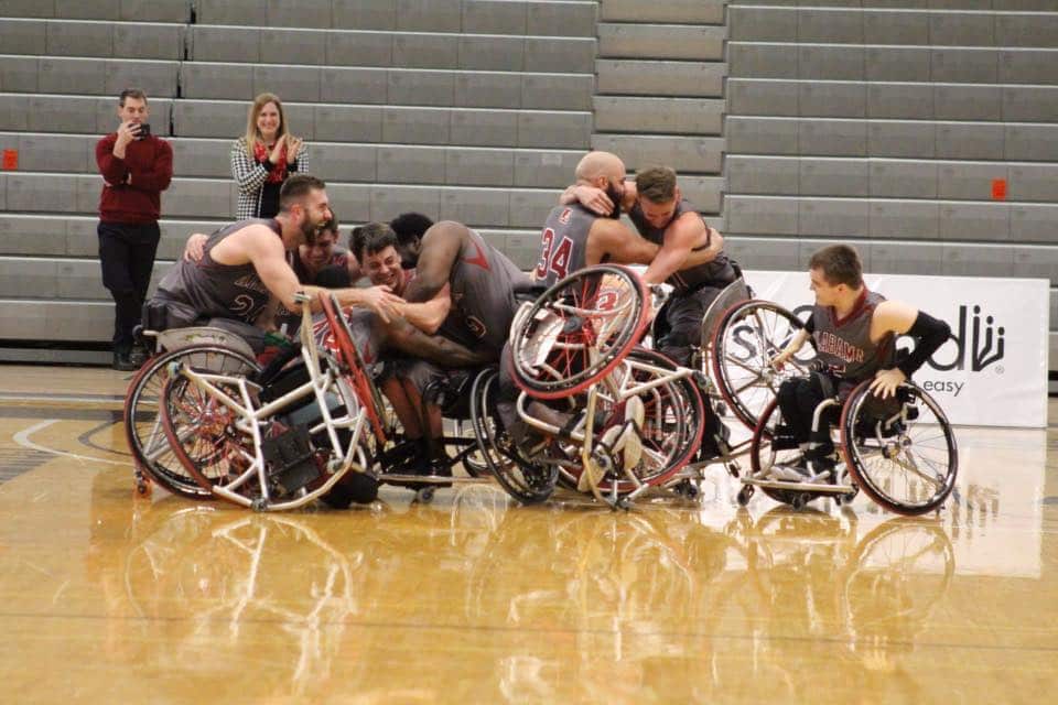 The Alabama Mens Wheelchair Basketball team embrace each other after winning the 2017-2018 National Championship.