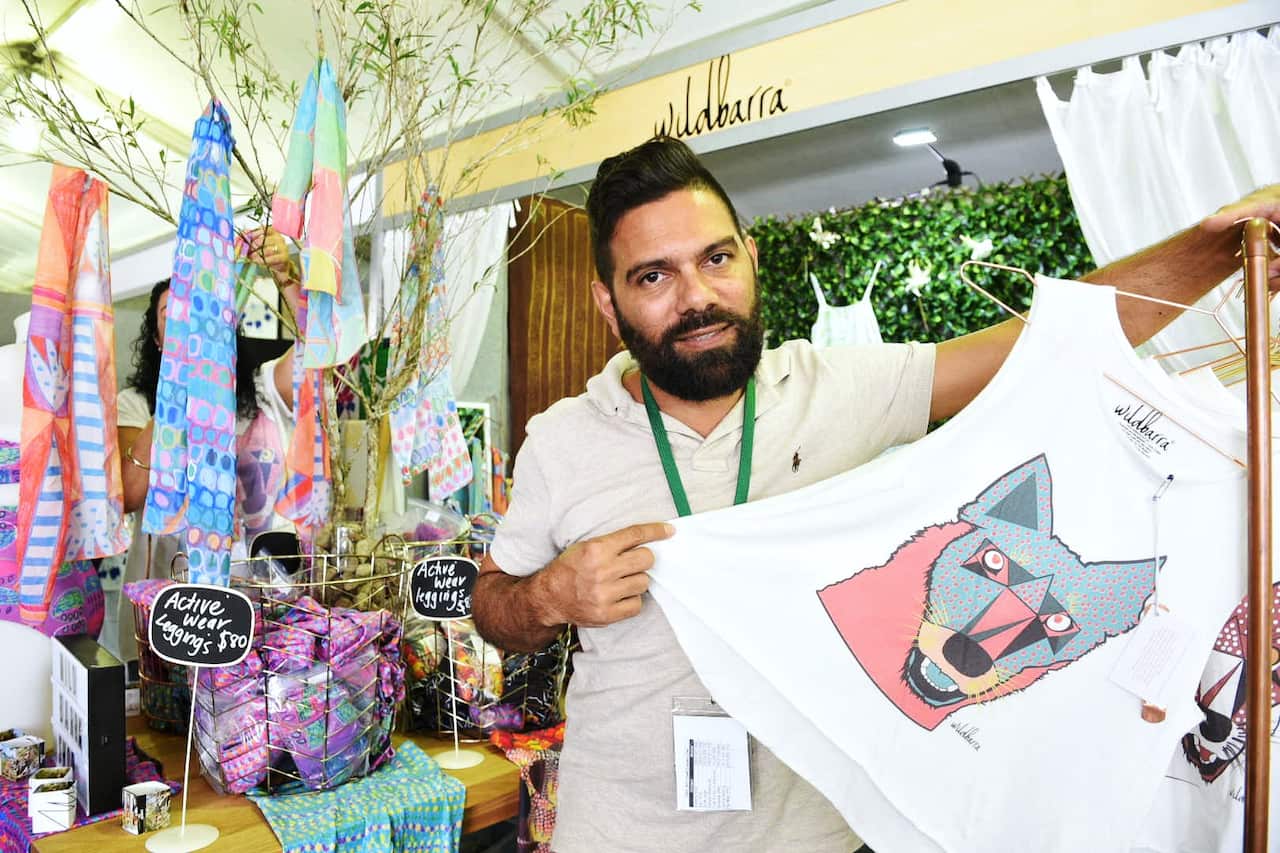 Edwards with his dingo design on a Wild Barra t-shirt.