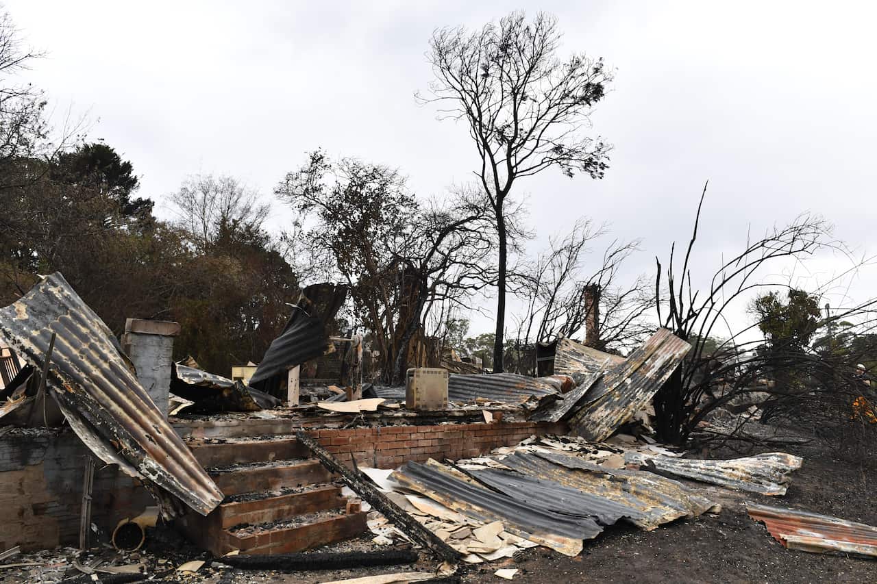 The burnt out remains of a house is seen from a bushfire in the Southern Highlands town of Wingello, 160km south west of Sydney.