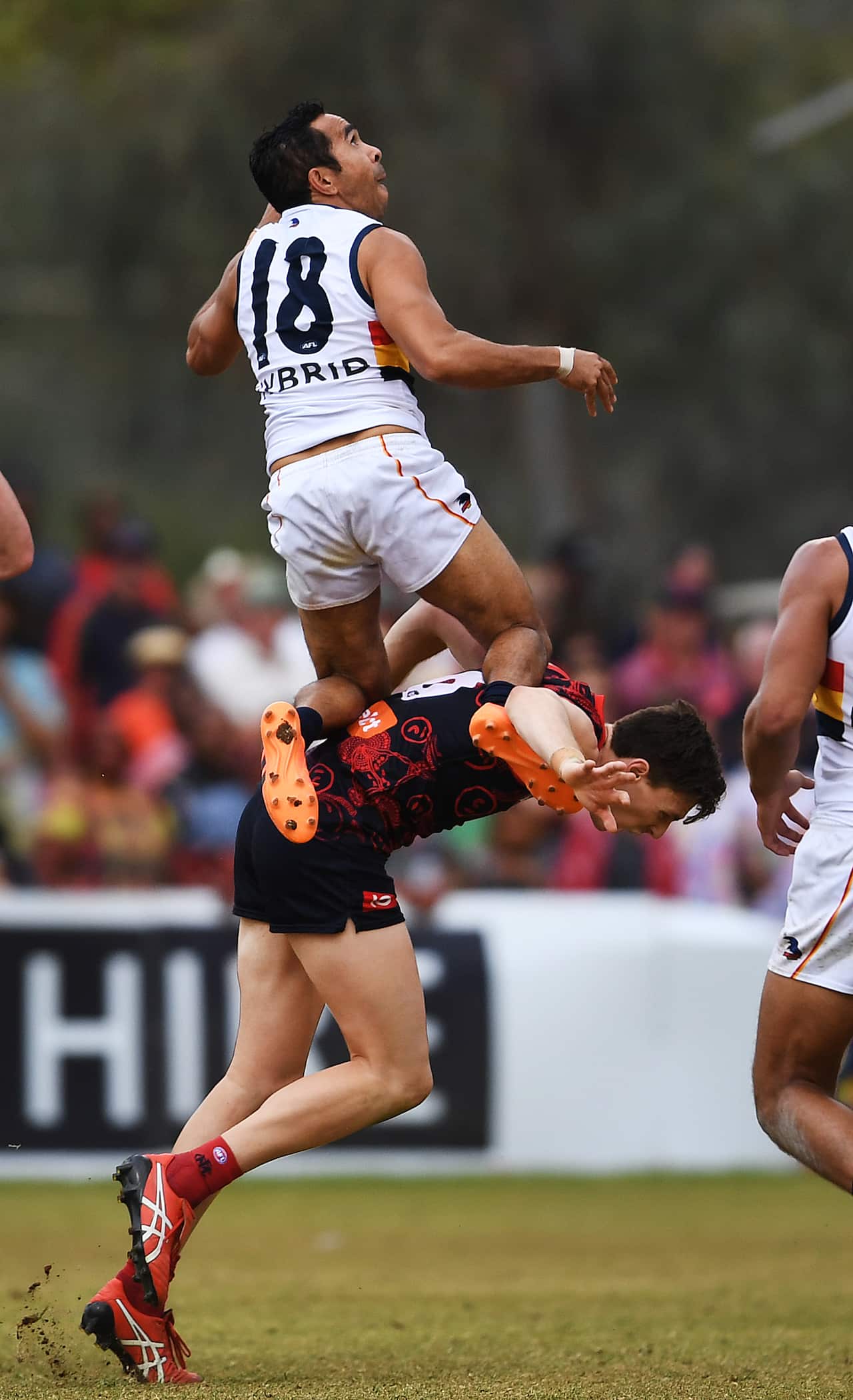Eddie Betts takes a screamer on top of Jake Lever from the Demons at Traegar Park Oval in Alice Springs, Sunday, May 27, 2018. 