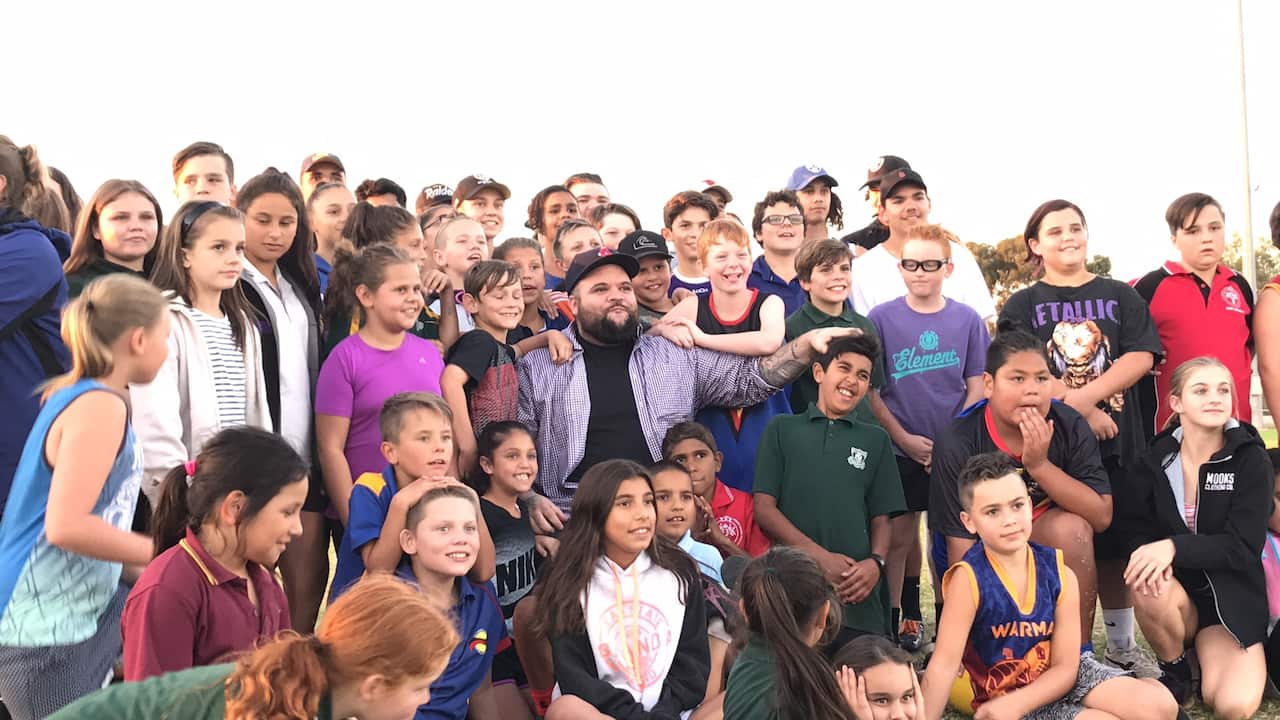 Briggs with school kids