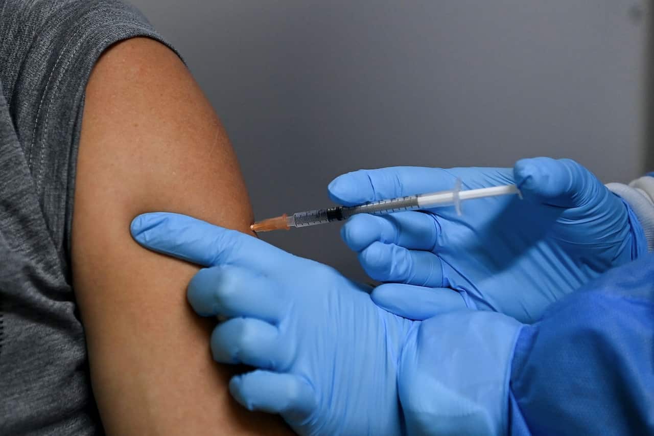 A patient receives the Pfizer COVID-19 vaccination by a nurse at the Belmore Medical GP in the suburb of Belmore, Sydney, Saturday, August 28, 2021.