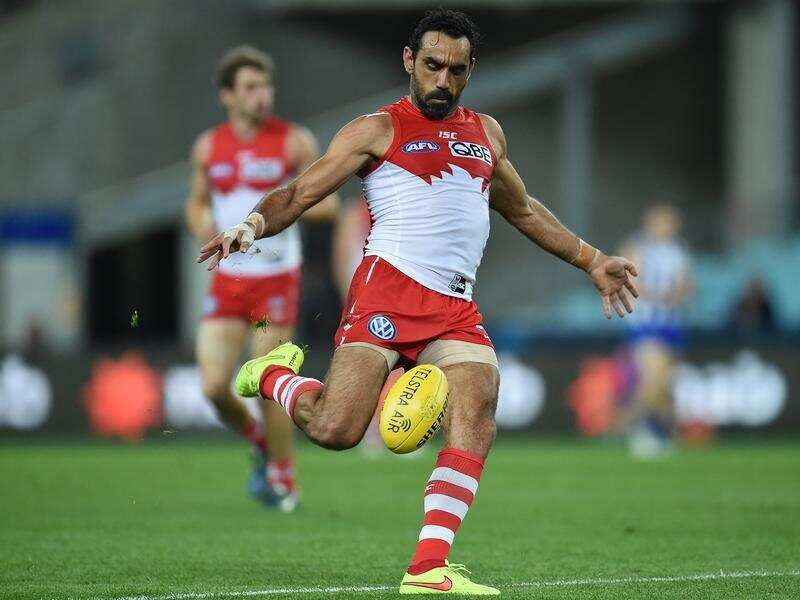 Adam Goodes of the Swans kicks.